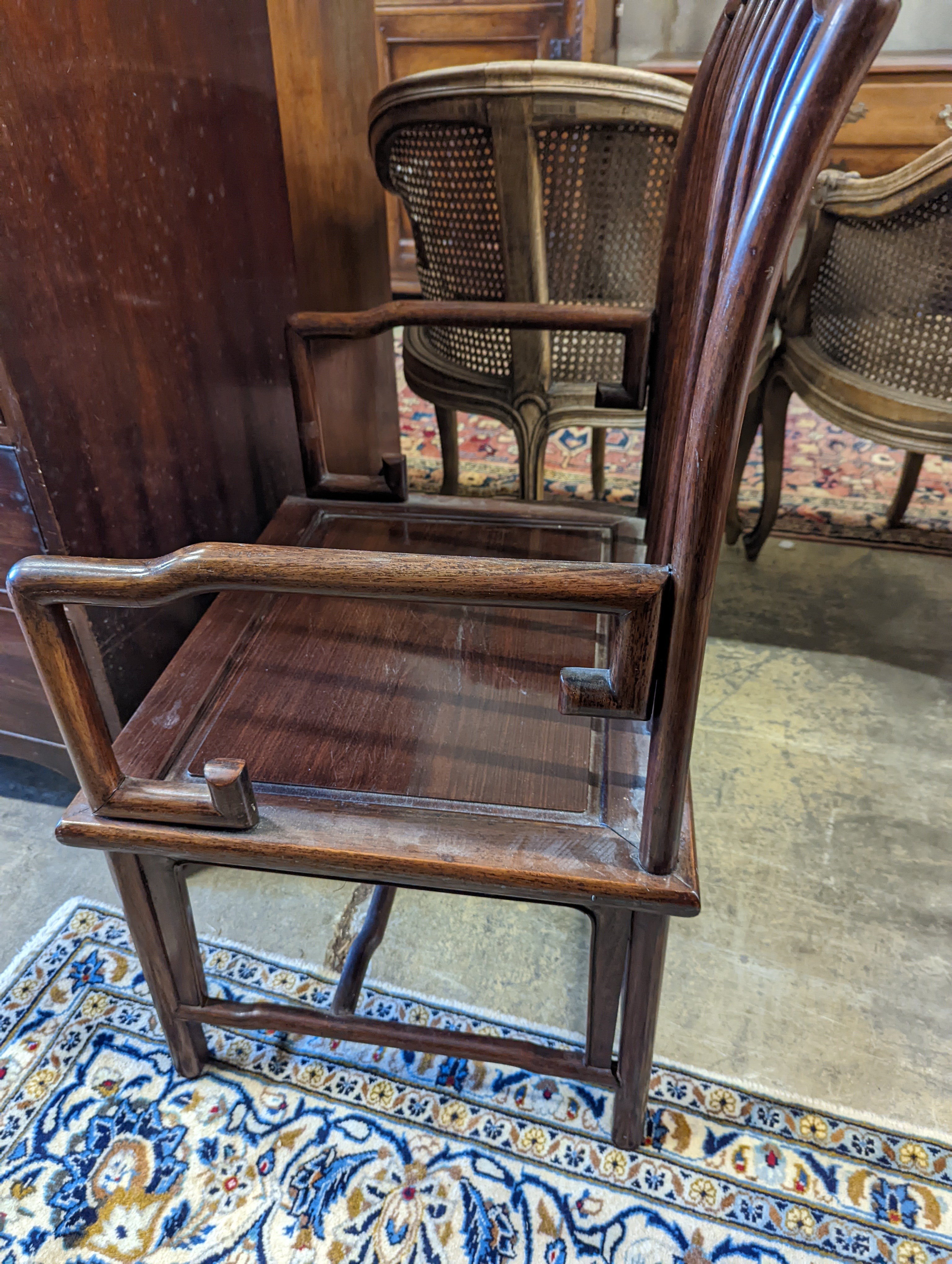 A pair of mid 20th century Chinese Hongmu elbow chairs with cushion seats, width 58cm, depth 49cm, height 92cm